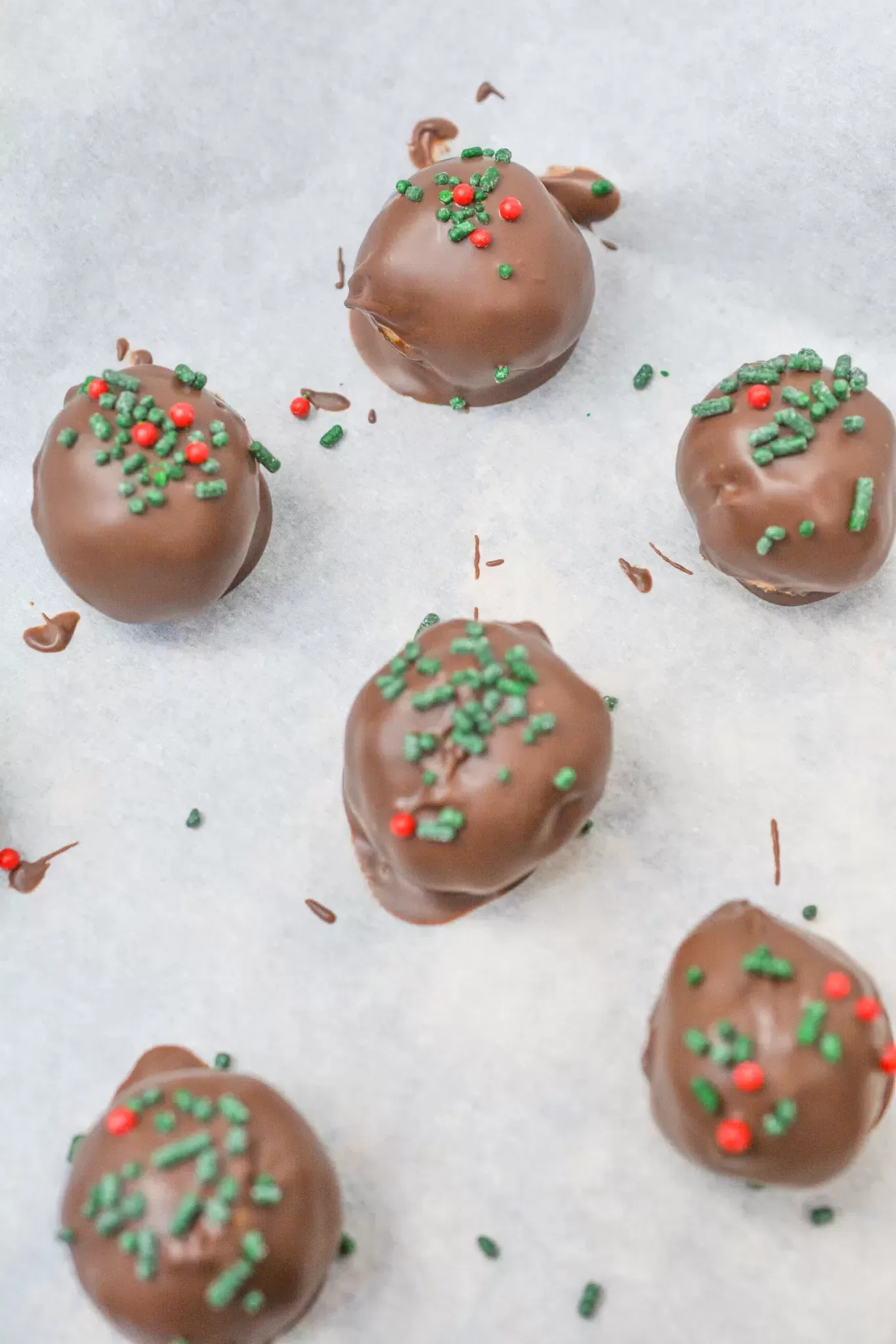 Dipping the peanut butter balls into melted chocolate almond bark.