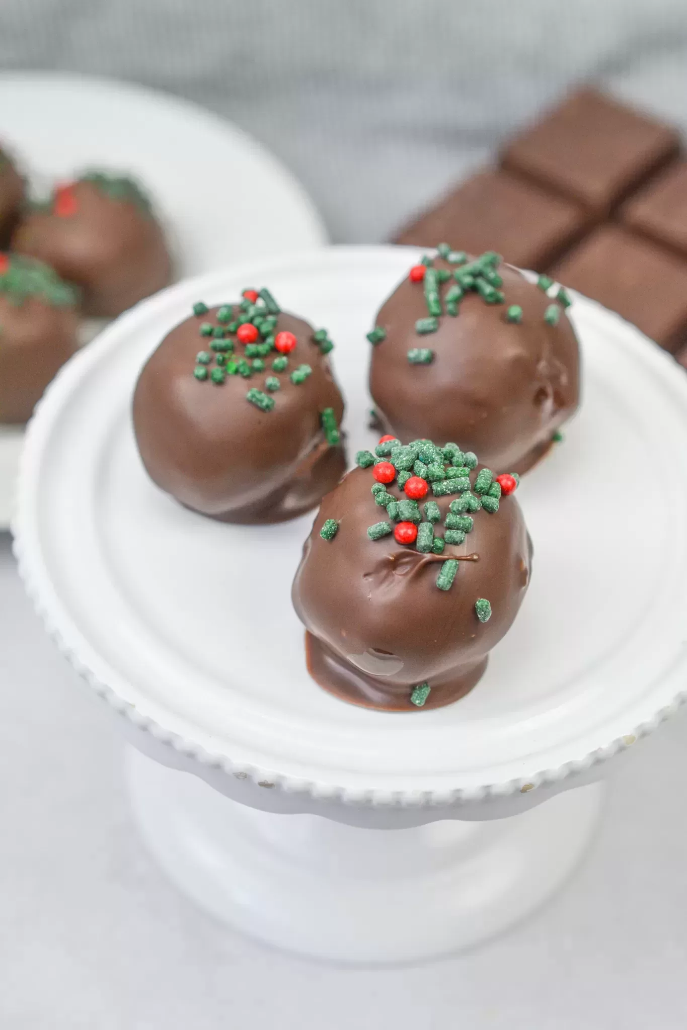 Close-up of chocolate-dipped peanut butter balls on parchment paper.