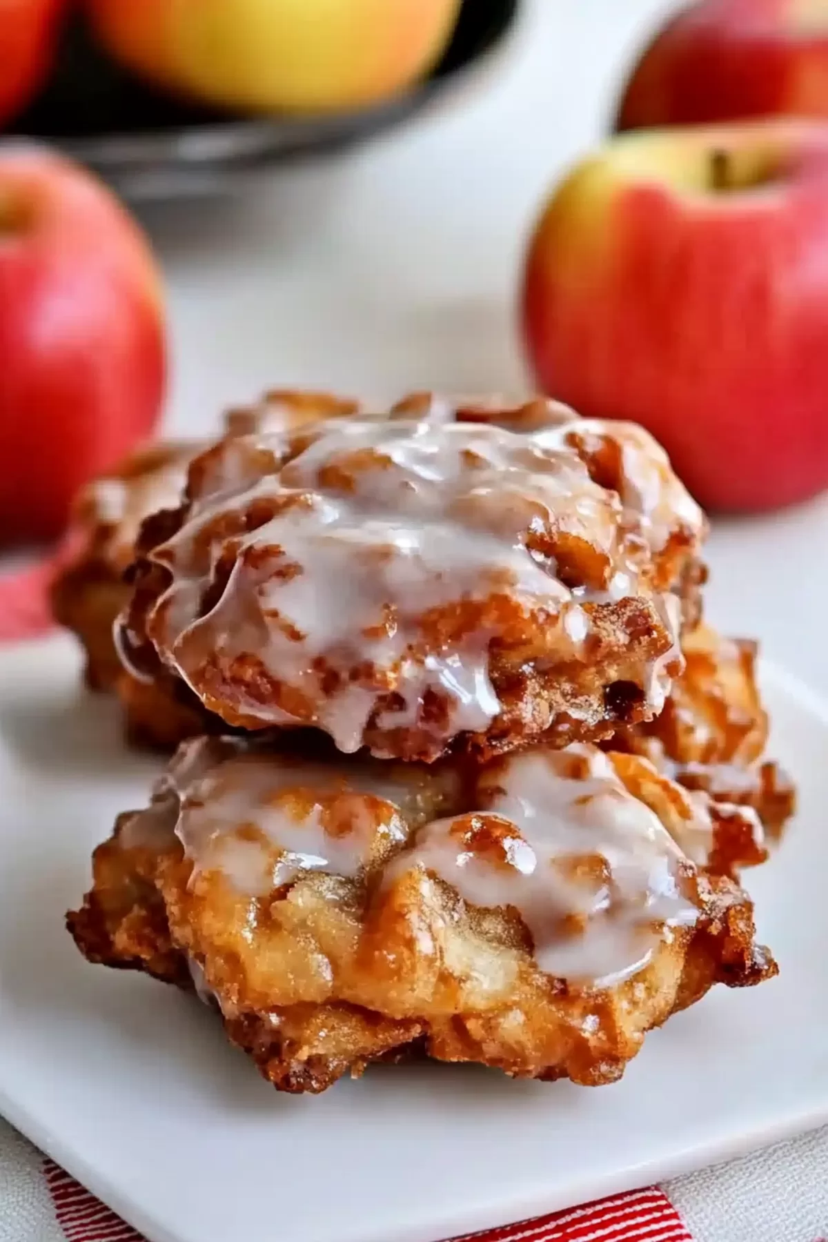 Golden-brown fried pastry drizzled with a shiny glaze, showcasing its crispy edges.