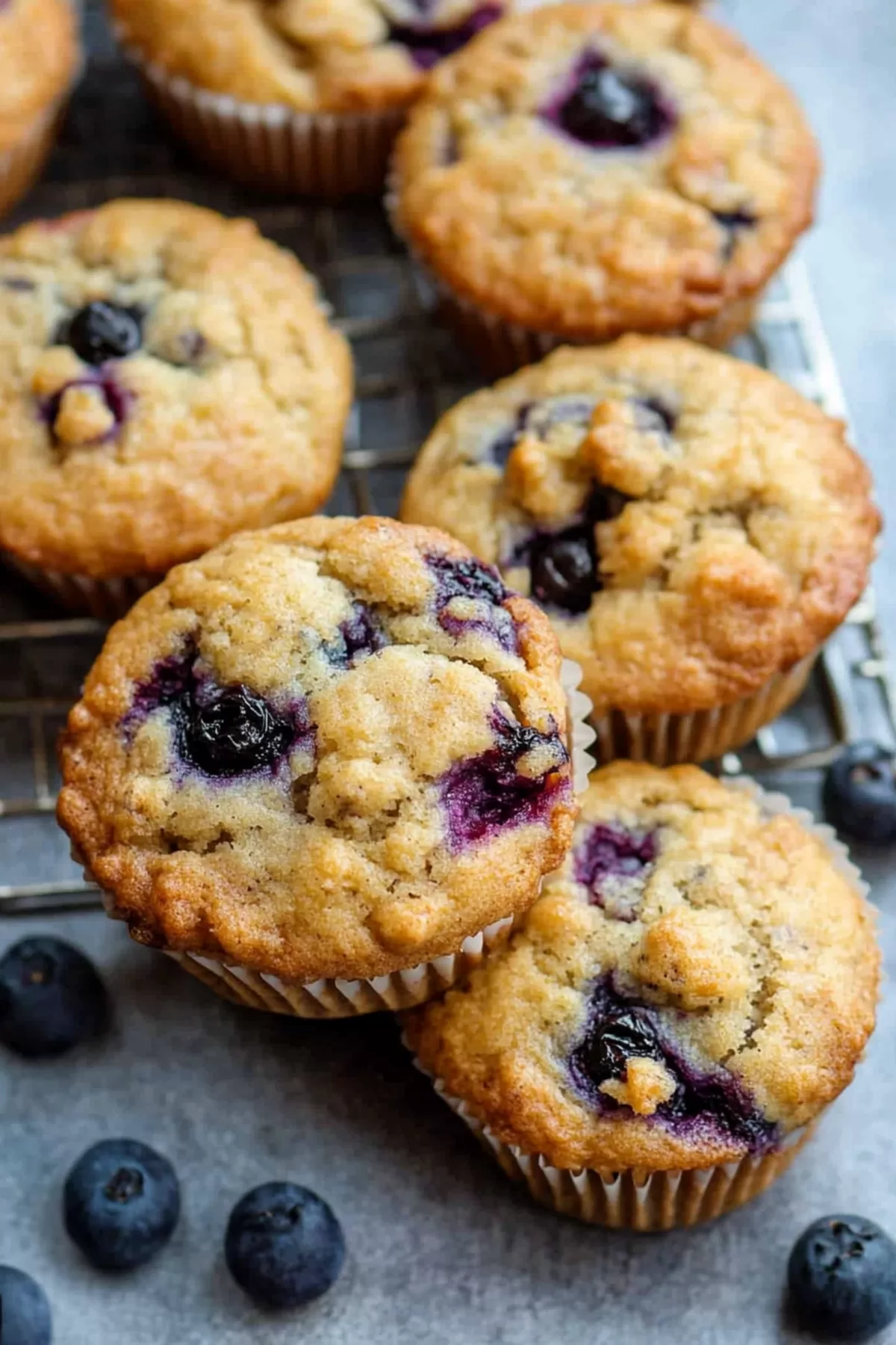 Golden muffins bursting with juicy blueberries, topped with a light lemon glaze.