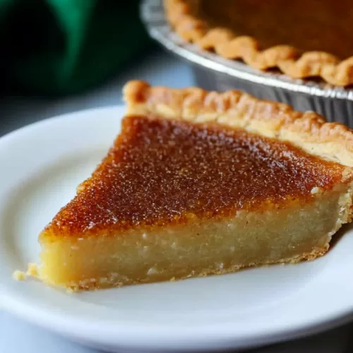 A rich, creamy pie slice on a plate with a fork, highlighting its smooth texture.