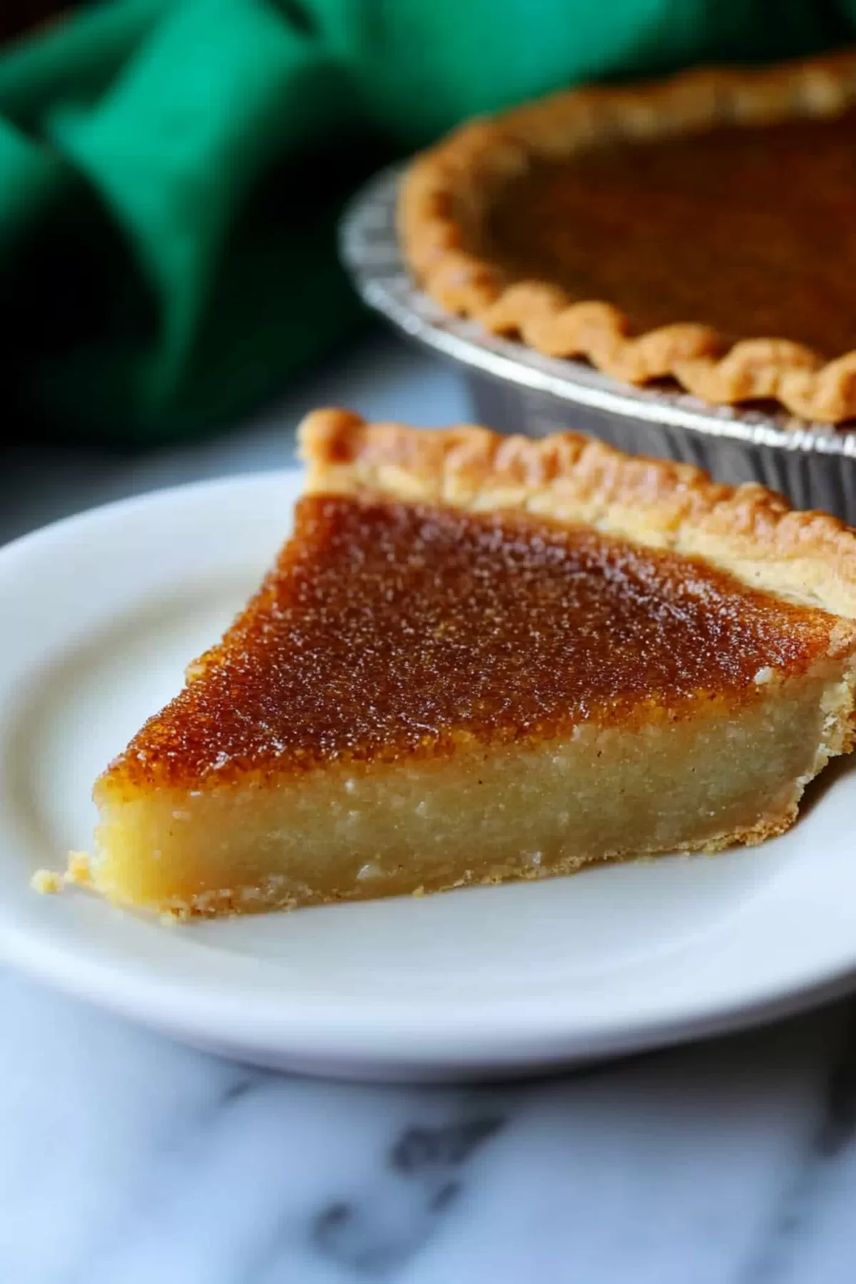 A rich, creamy pie slice on a plate with a fork, highlighting its smooth texture.