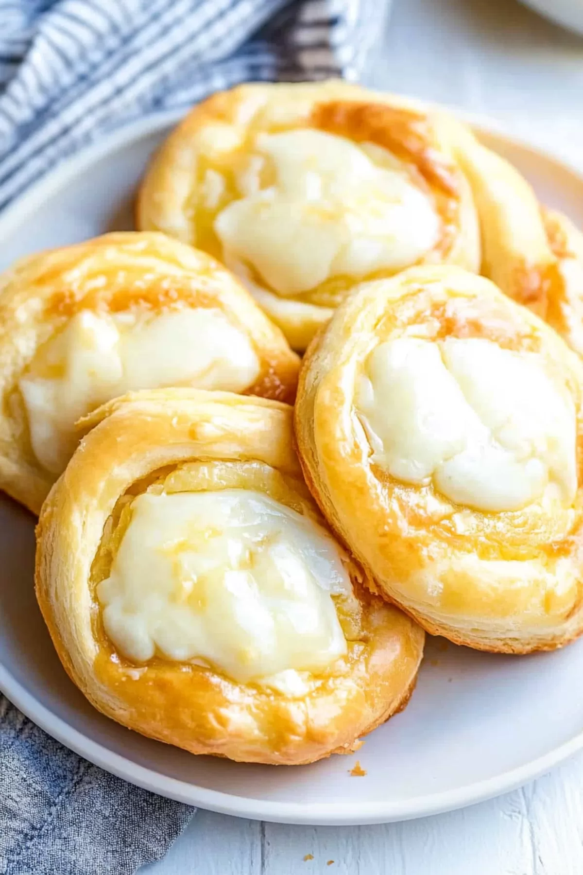 Buttery crescent pastries showcasing a creamy center and delicate layers.