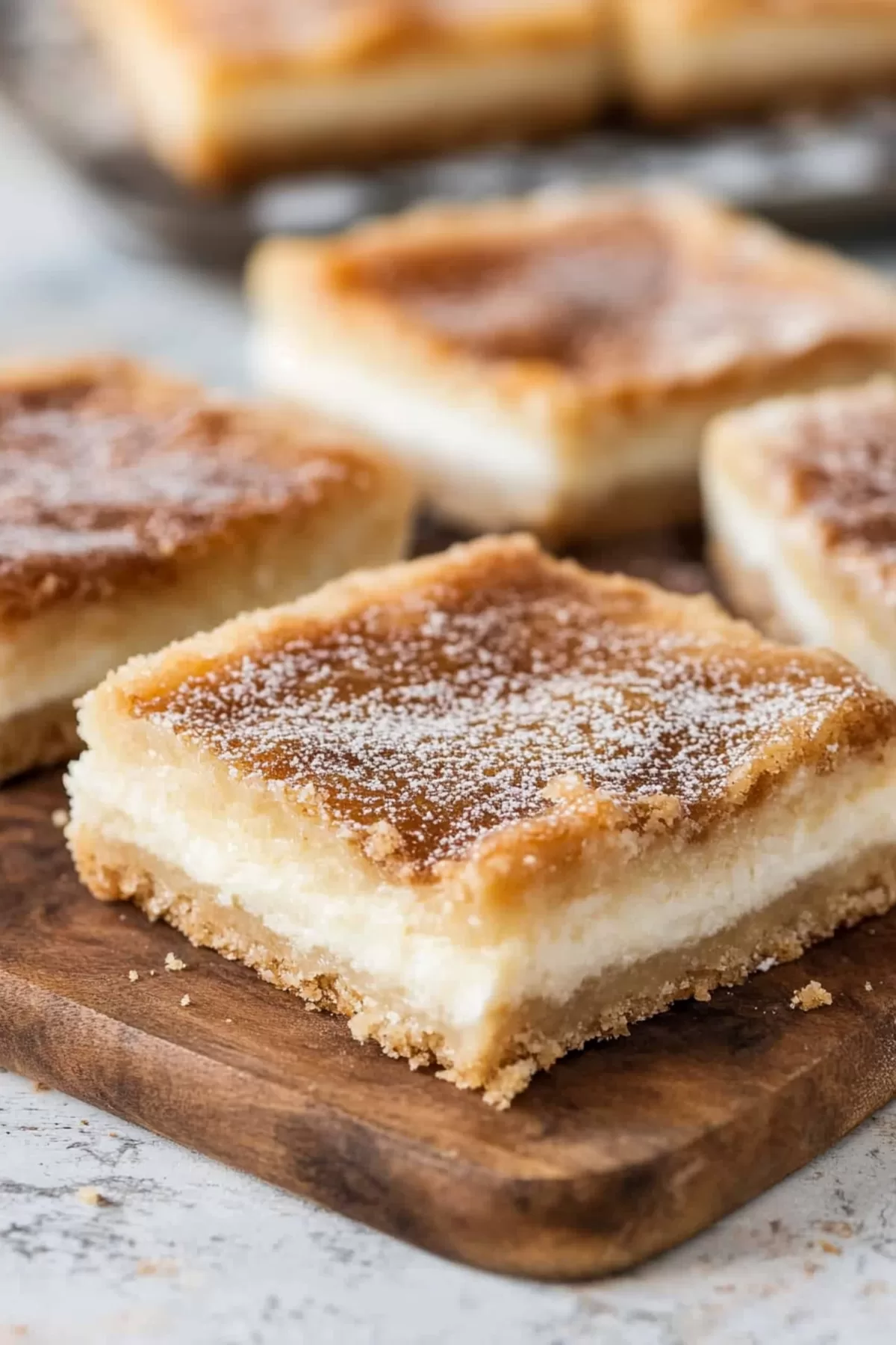 Golden, flaky bars layered with creamy cheesecake filling, perfect for dessert.