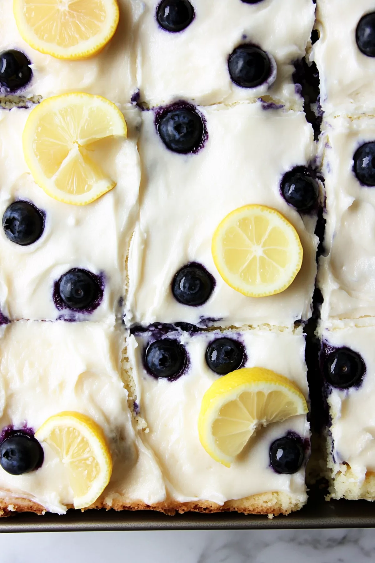 Sliced cake featuring fluffy layers and juicy blueberries, arranged on a serving tray