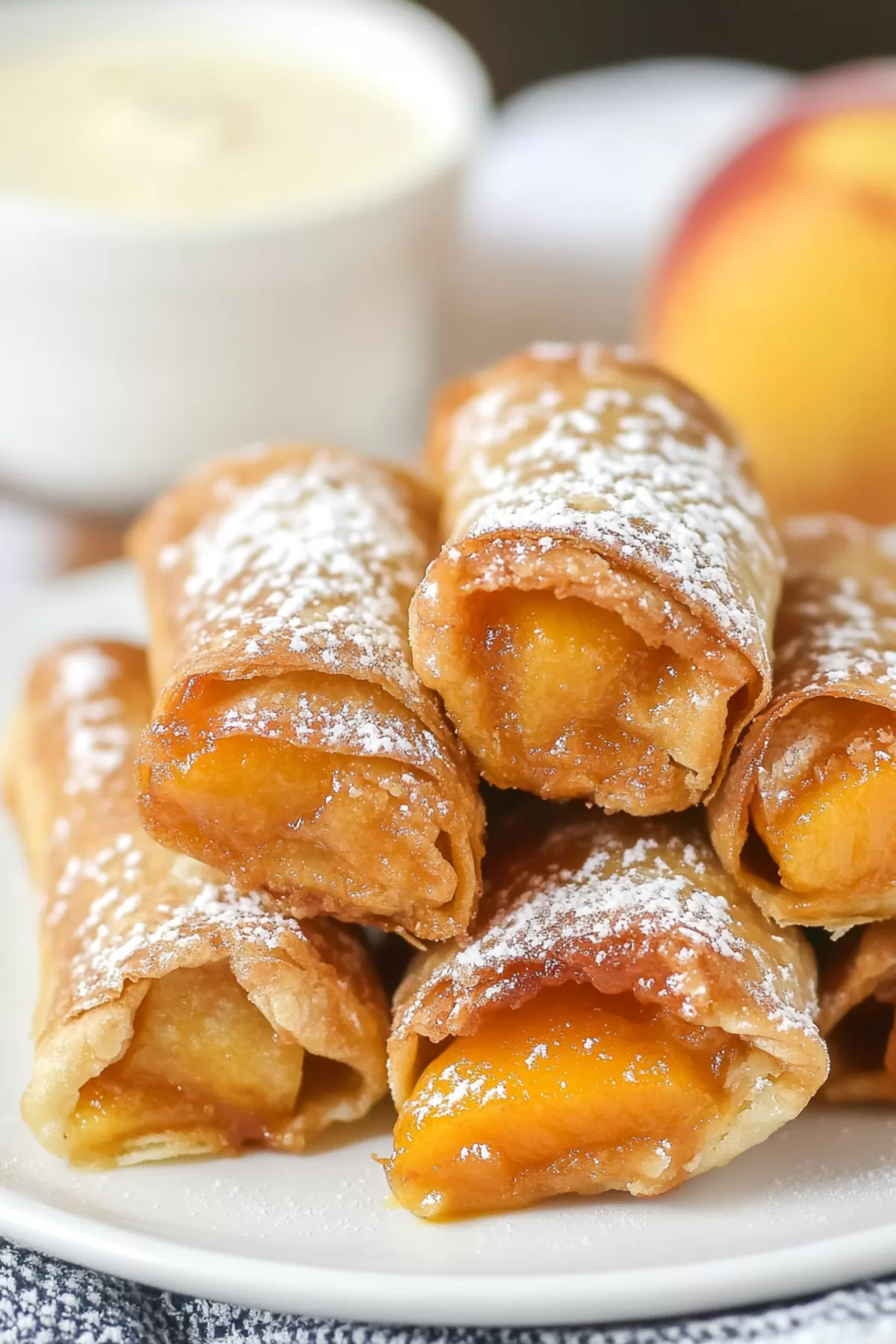 Golden, crispy egg rolls dusted with powdered sugar and served with a scoop of vanilla ice cream.