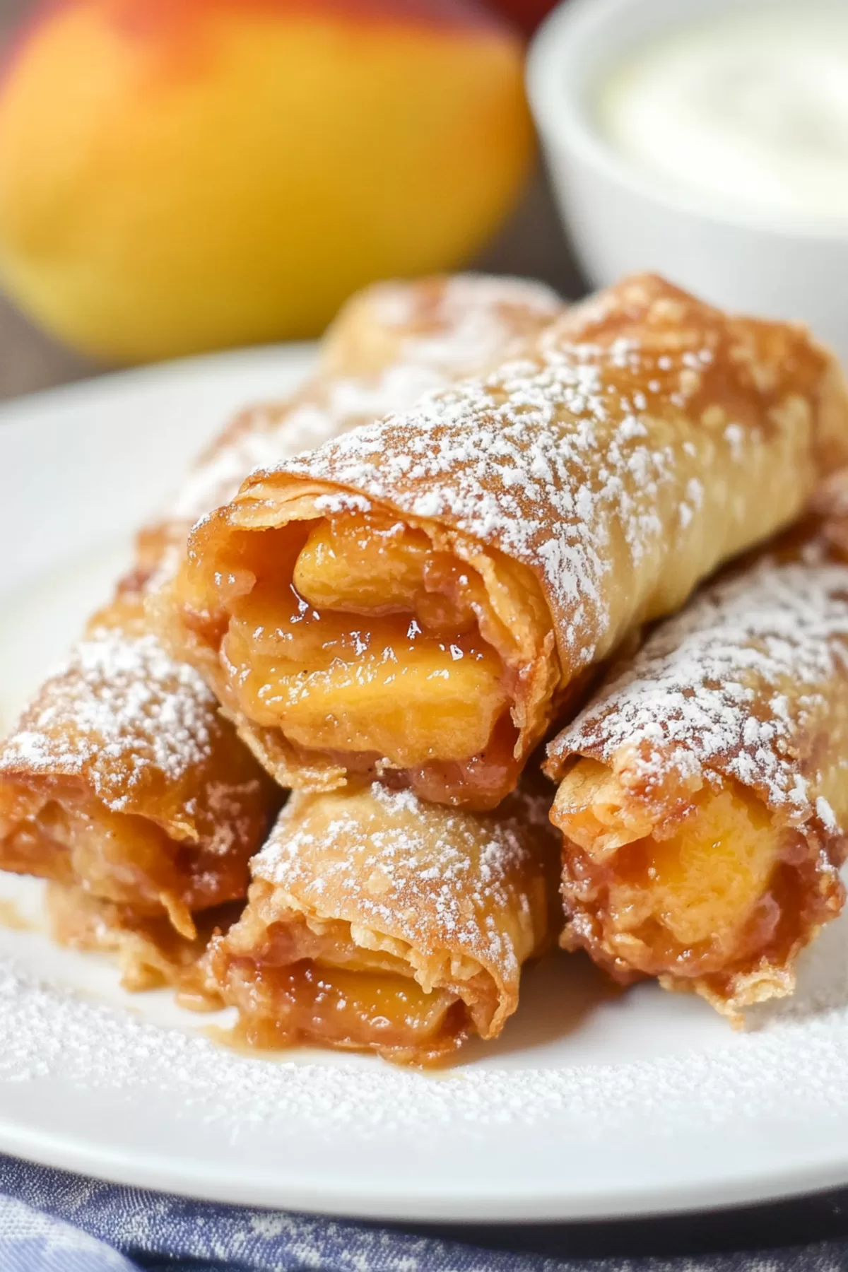 Close-up of a dessert roll filled with sweet peach filling, showcasing its flaky crust.