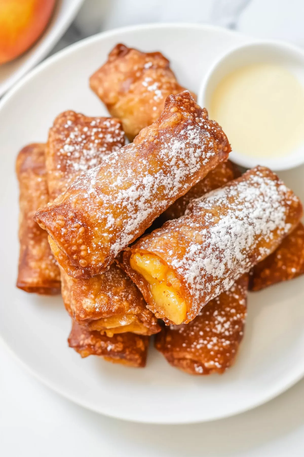 Crispy rolls filled with a spiced peach mixture, perfect for a sweet treat.