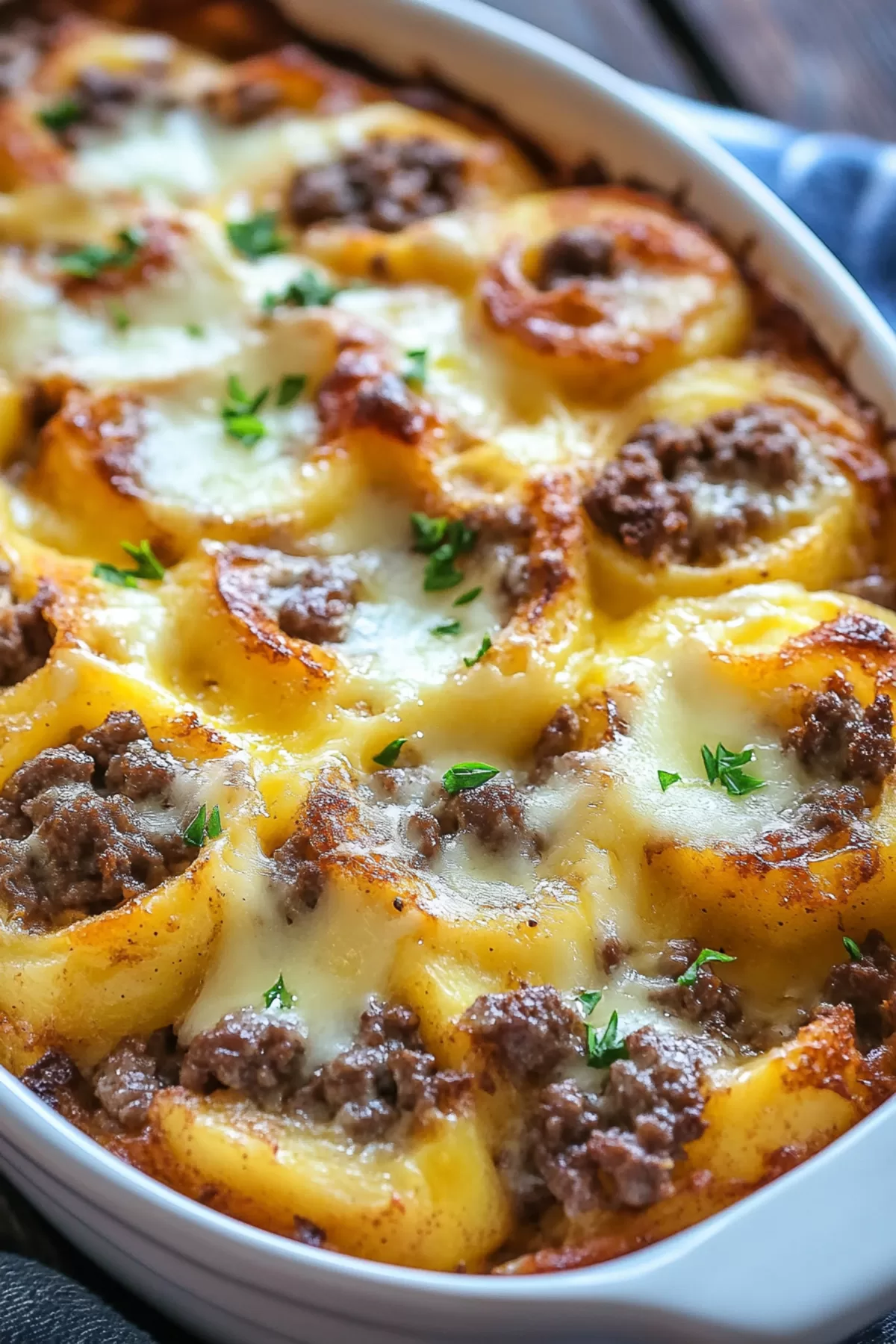 A serving of Hamburger Potato casserole showing tender potatoes and a creamy, cheesy sauce.