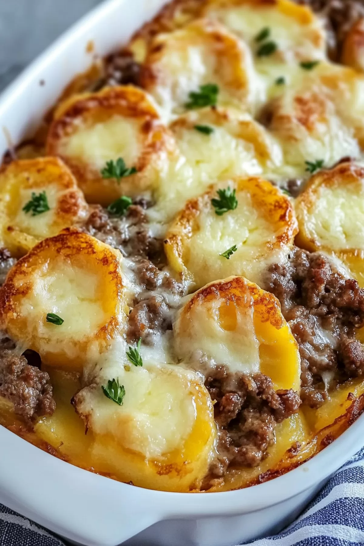 Layered Hamburger Potato Casserole with beef and potatoes, topped with a generous amount of melted cheese.