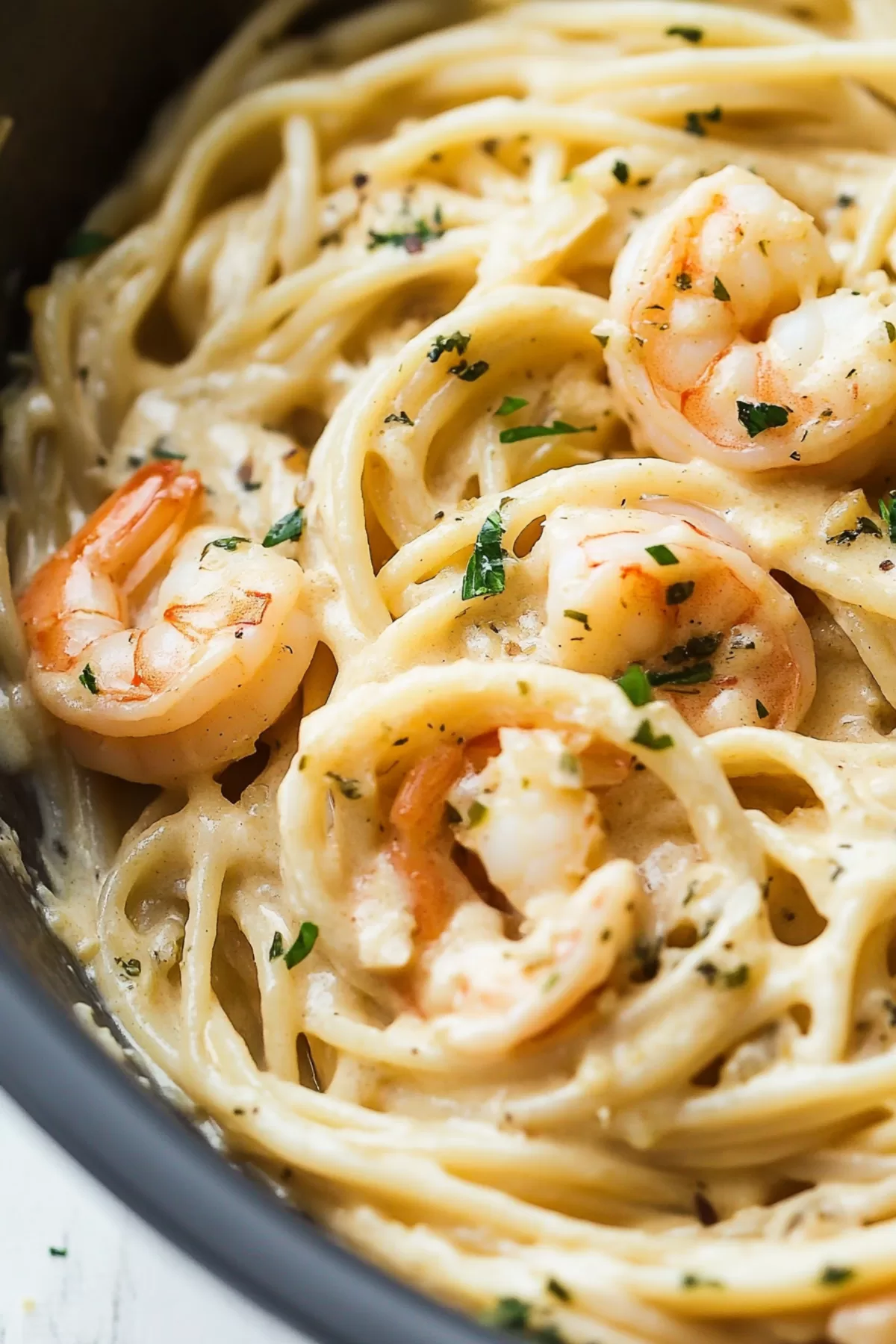 Rich and creamy pasta swirled with shrimp and topped with herbs for a comforting meal.