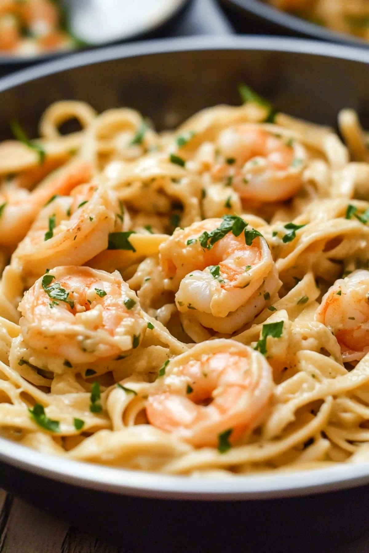 Thick fettuccine coated in a smooth sauce, paired with juicy shrimp and a hint of fresh herbs.