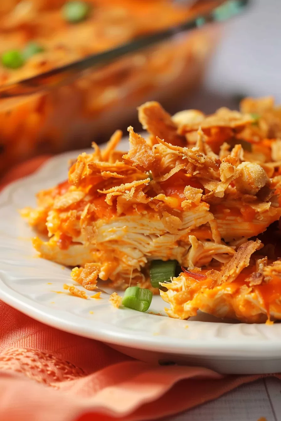 A plate of Mexican Dorito chicken casserole served fresh, showcasing the crunchy chip topping and gooey cheese.