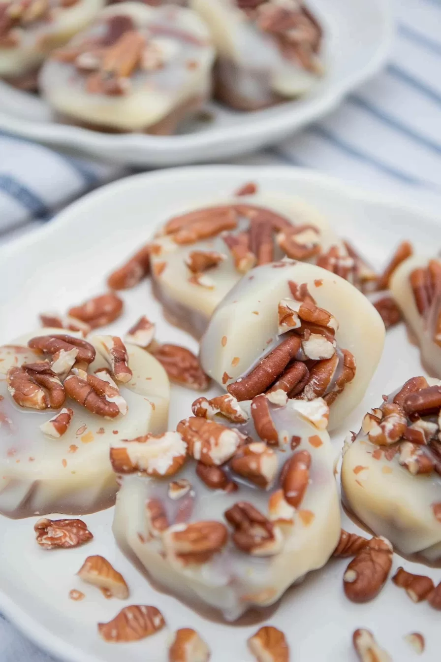 Close-up view of homemade pecan candies with a smooth caramel coating.