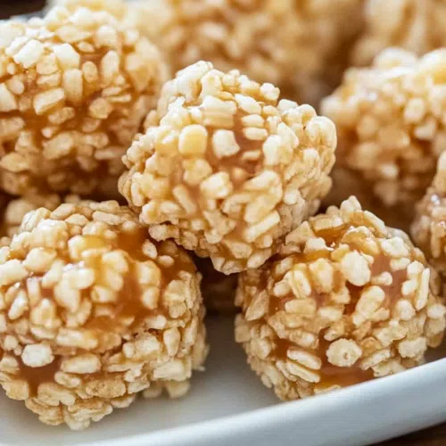 Golden caramel-dipped rice cereal bites arranged for serving.