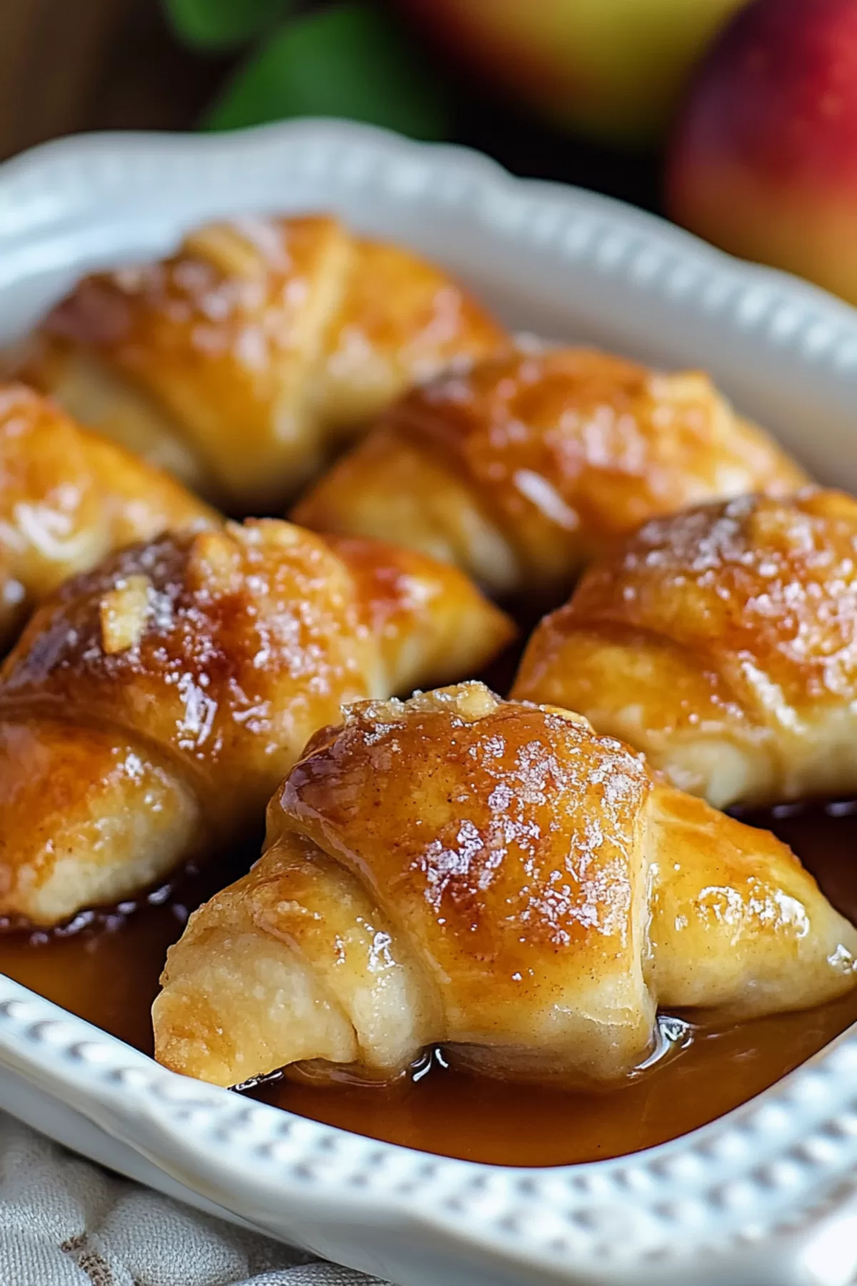 Golden-brown baked dumplings with a caramelized glaze and tender apple filling.