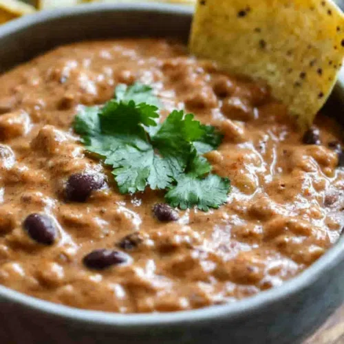 Warm, cheesy dip served with tortilla chips for dipping.