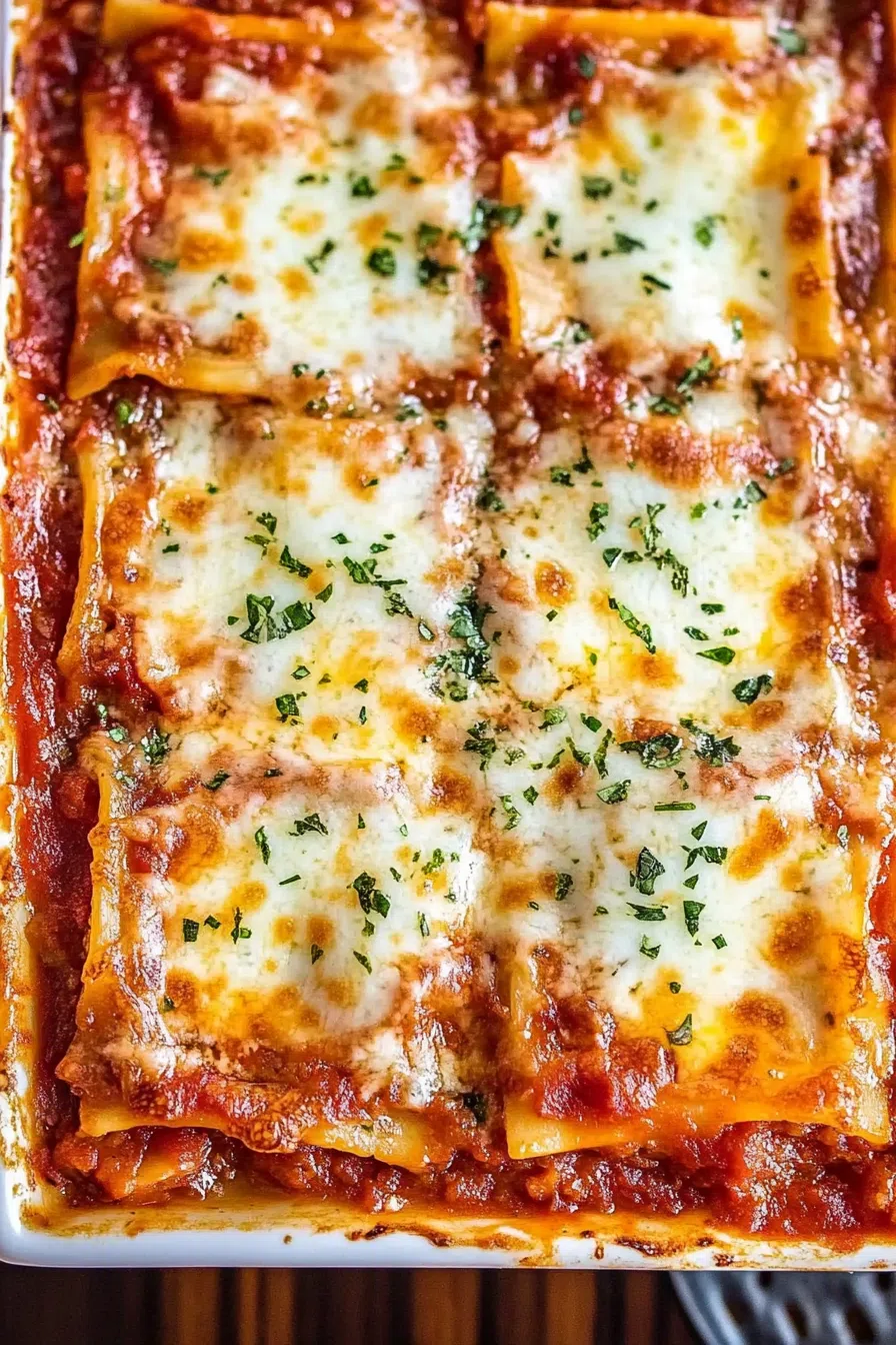 An overhead shot of the entire lasagna in the baking dish, garnished with fresh basil leaves.