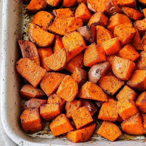Warm, crispy potato pieces served on a white platter.