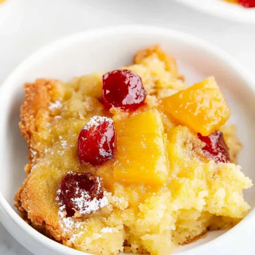 Overhead shot of the whole cake, showcasing its golden-brown crust and vibrant fruit layer.