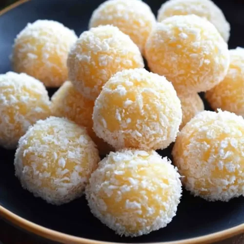 A plate of snow-like dessert balls, perfect for a Christmas celebration.