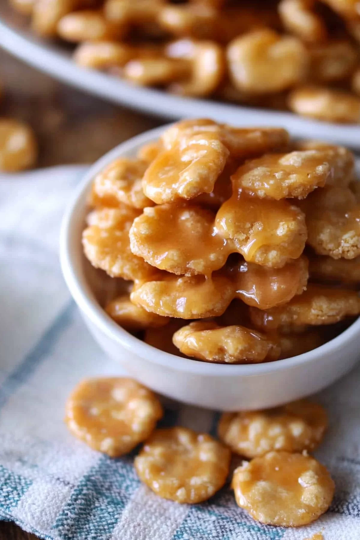 A small white bowl filled with caramel-covered crackers, perfect for a sweet and salty treat.