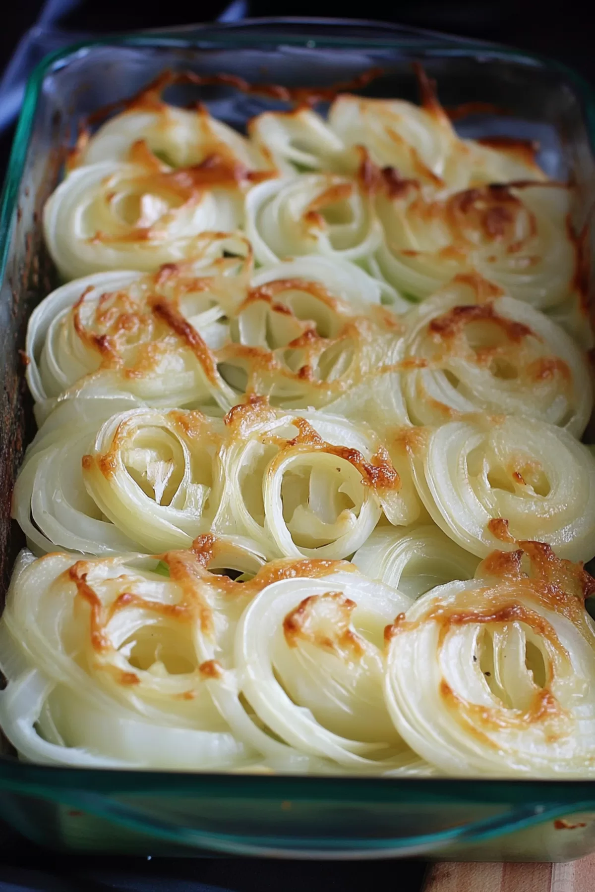 Layered Vidalia onions with a golden, bubbling cheese crust.