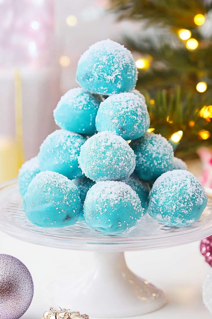 A batch of homemade truffles arranged on a tray, each with a vibrant blue coating.