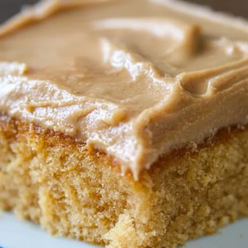 A close-up of a freshly baked dessert with glistening fruit and a soft, tender texture.