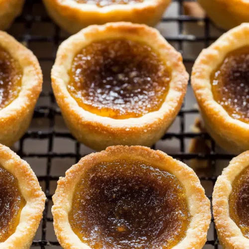 Gooey-filled pastry shells arranged on a cooling rack.