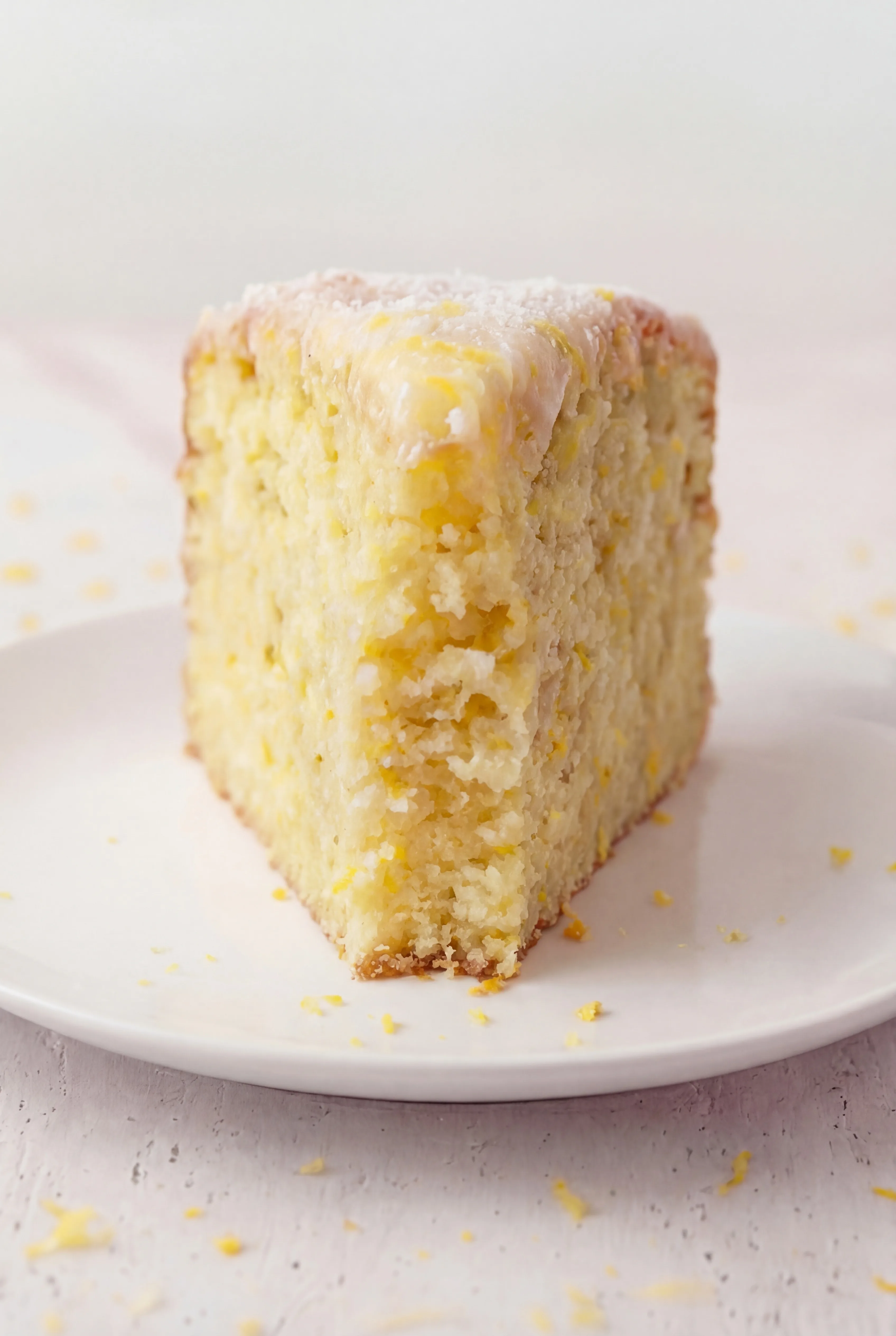 fork lifting bite of lemon ricotta cake with moist fluffy texture and citrus flavor