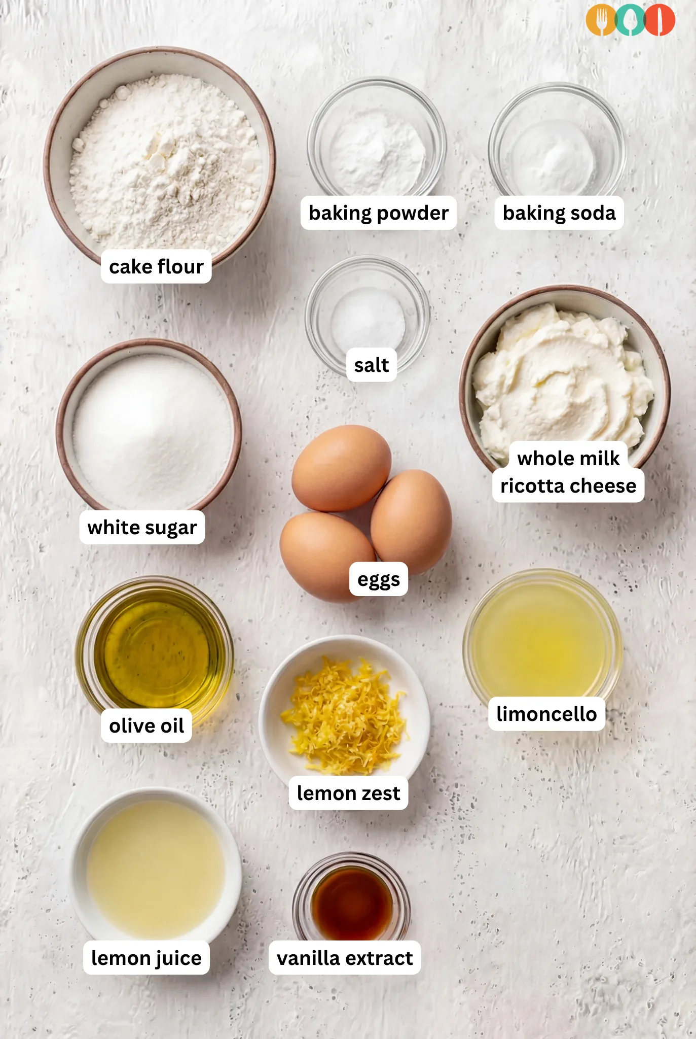 ingredients for Limoncello Ricotta Cake including ricotta cheese, eggs, lemon zest, limoncello, cake flour, sugar, and olive oil
