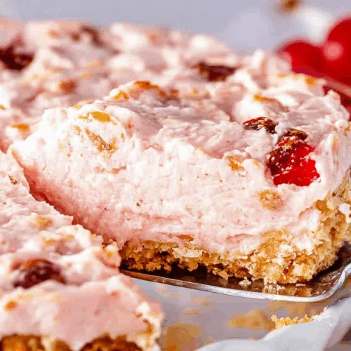 Close-up of a creamy pie with crushed pecans on top.