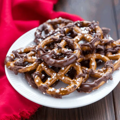 A pile of glossy, sweet-and-salty treats arranged on a festive plate.