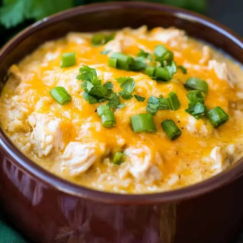 A golden, bubbly casserole garnished with fresh cilantro and a sprinkle of cheese.