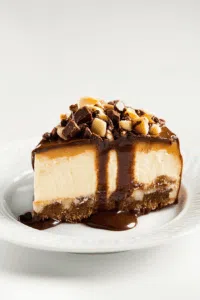 Side view of a rich layered treat on a serving plate.