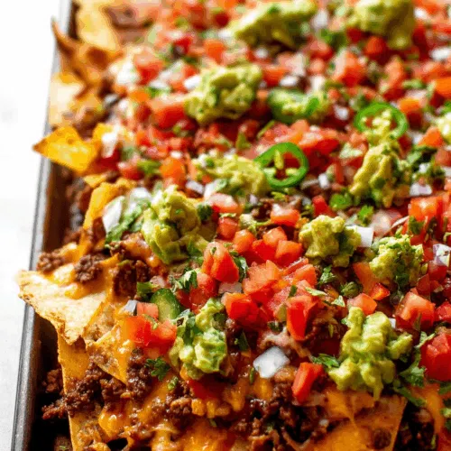 Piled-high snack served with dollops of sour cream and salsa.