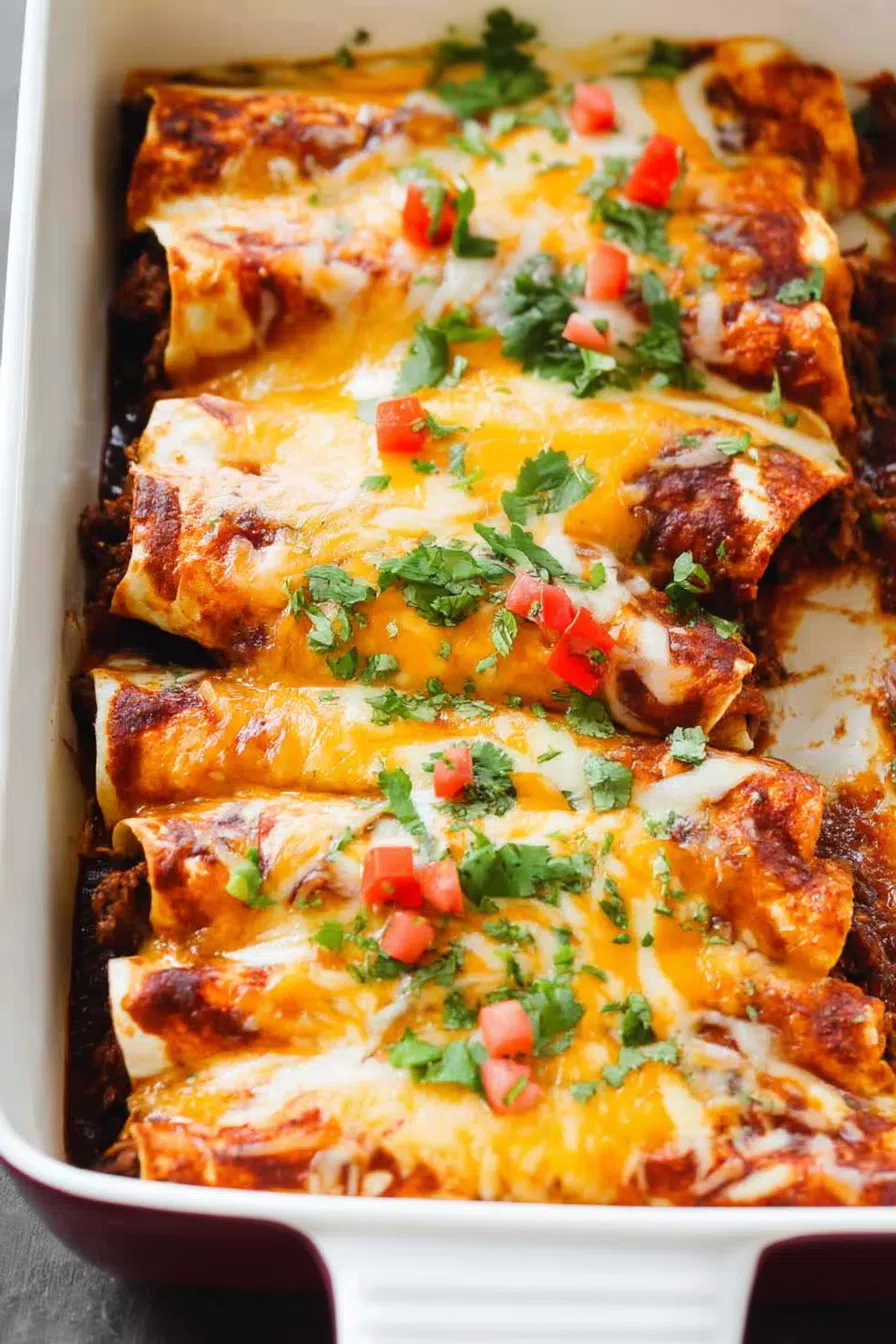 Golden-brown enchiladas arranged neatly in a baking dish, fresh out of the oven.