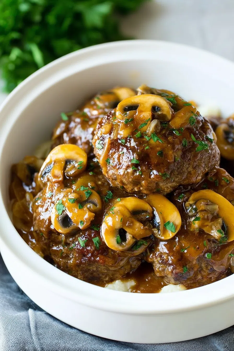 Overhead view of a hearty dinner plate featuring meat in savory sauce.