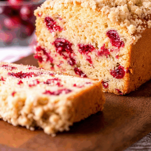 Close-up of a thick slice showcasing baked berries and a crunchy top layer.