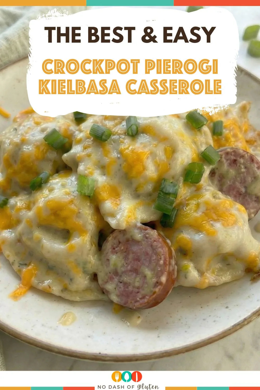 Close-up of cheesy pierogies with sliced kielbasa and green onions, topped with text reading “The Best & Easy Crockpot Pierogi Kielbasa Casserole”