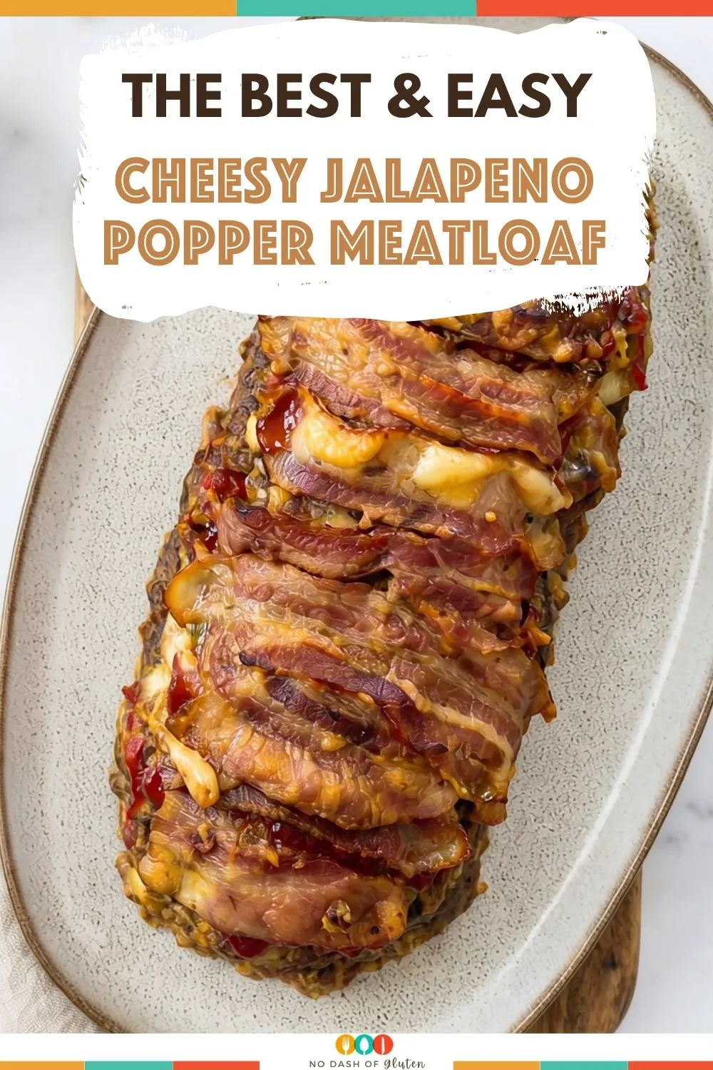 Bacon wrapped stuffed meatloaf with melted cheese and text overlay on image