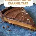 Slice of chocolate caramel tart on blue plate with text overlay