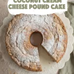 Coconut Cream Cheese Pound Cake topped with powdered sugar and sliced to show soft crumb