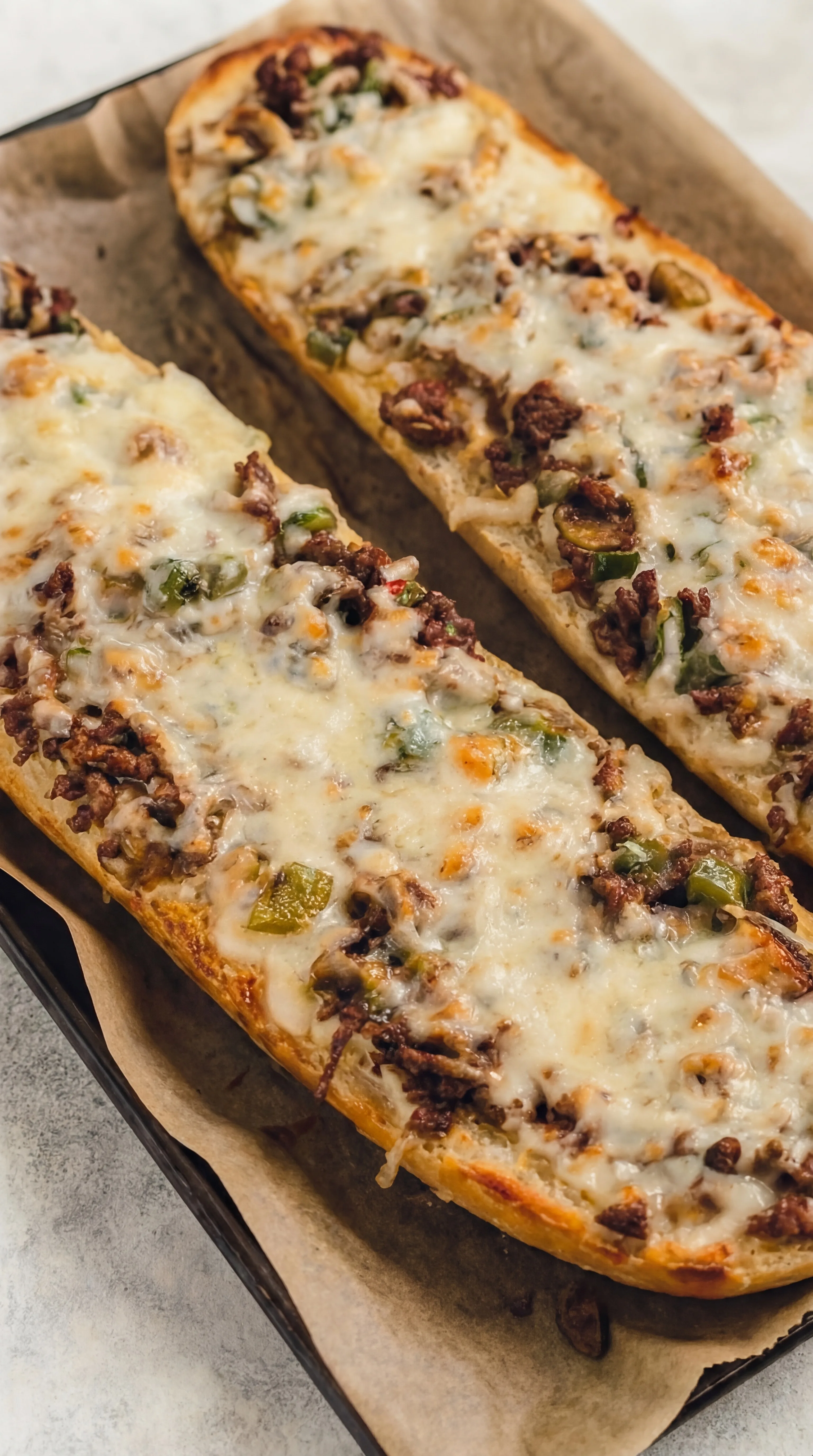 crispy toasted bread topped with juicy cheesesteak mixture and bubbling melted cheese