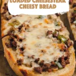 Loaded Cheesesteak Cheesy Bread topped with seasoned beef, peppers, mushrooms, and melted cheese
