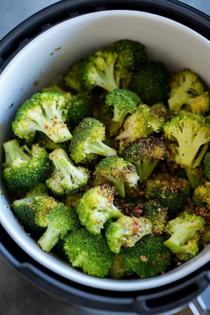 A serving of perfectly cooked broccoli garnished with a touch of lemon zest.