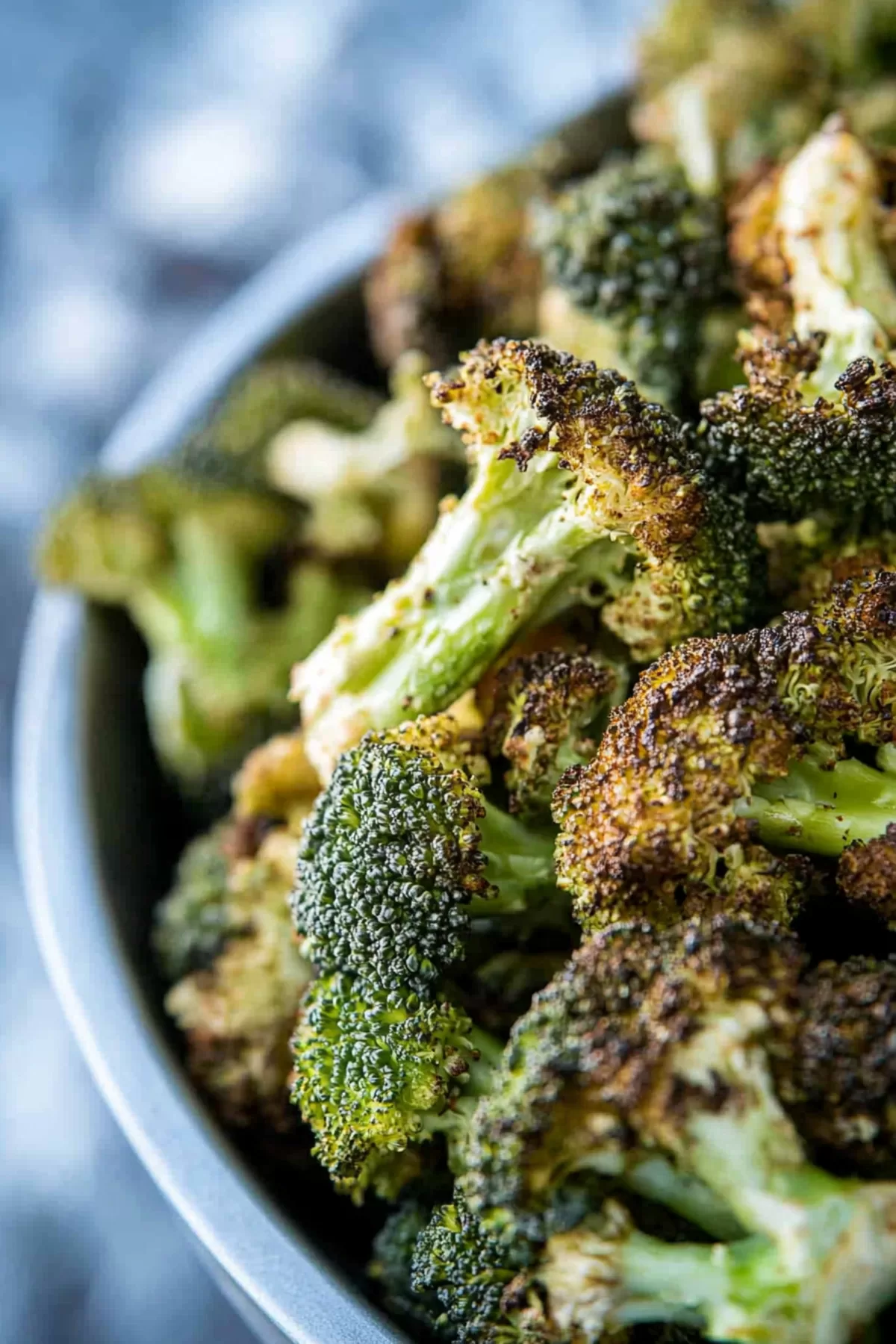 Crispy, golden-brown florets served on a white plate with a sprinkle of seasoning.