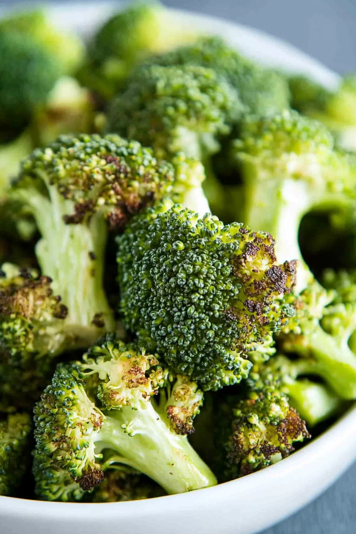 Close-up of tender roasted greens with lightly charred edges.