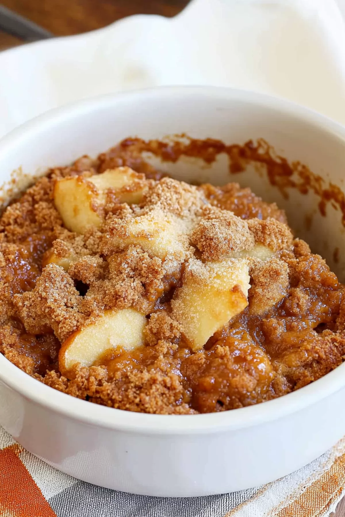 Side view of Apple Brown Betty showcasing chunks of apple and cinnamon crumble.